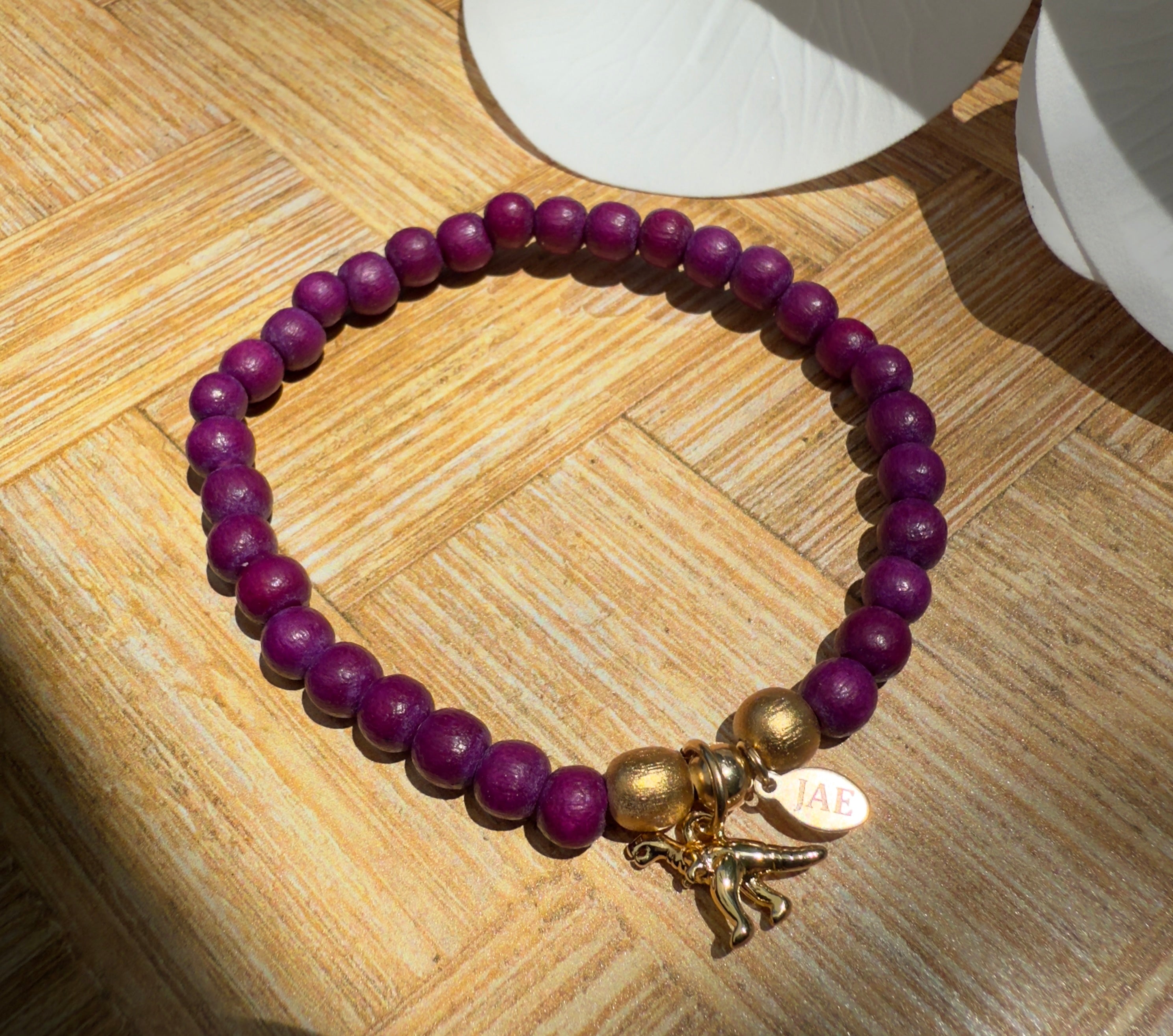 Cranberry Colored Wooden Bead Slip-on Style Bracelet with T-Rex Charm