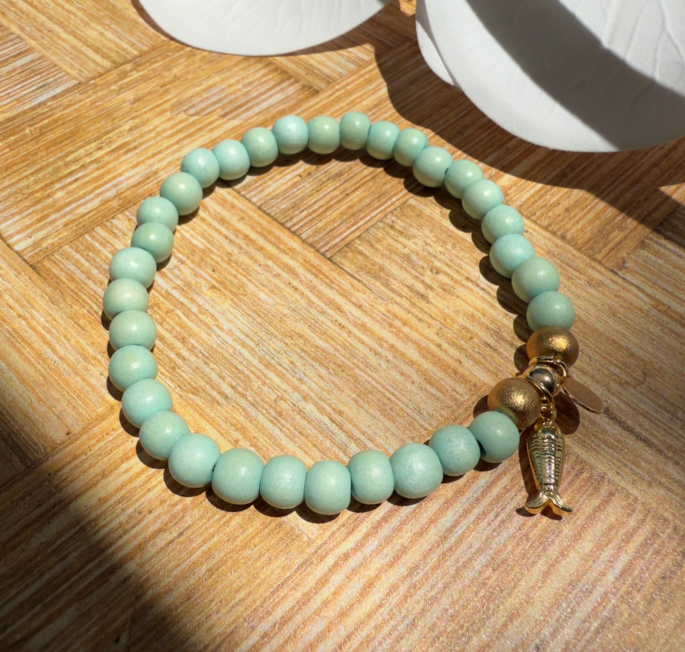 Seafoam Colored Wooden Bead Slip-on Style Bracelet with Textured Fish Charm