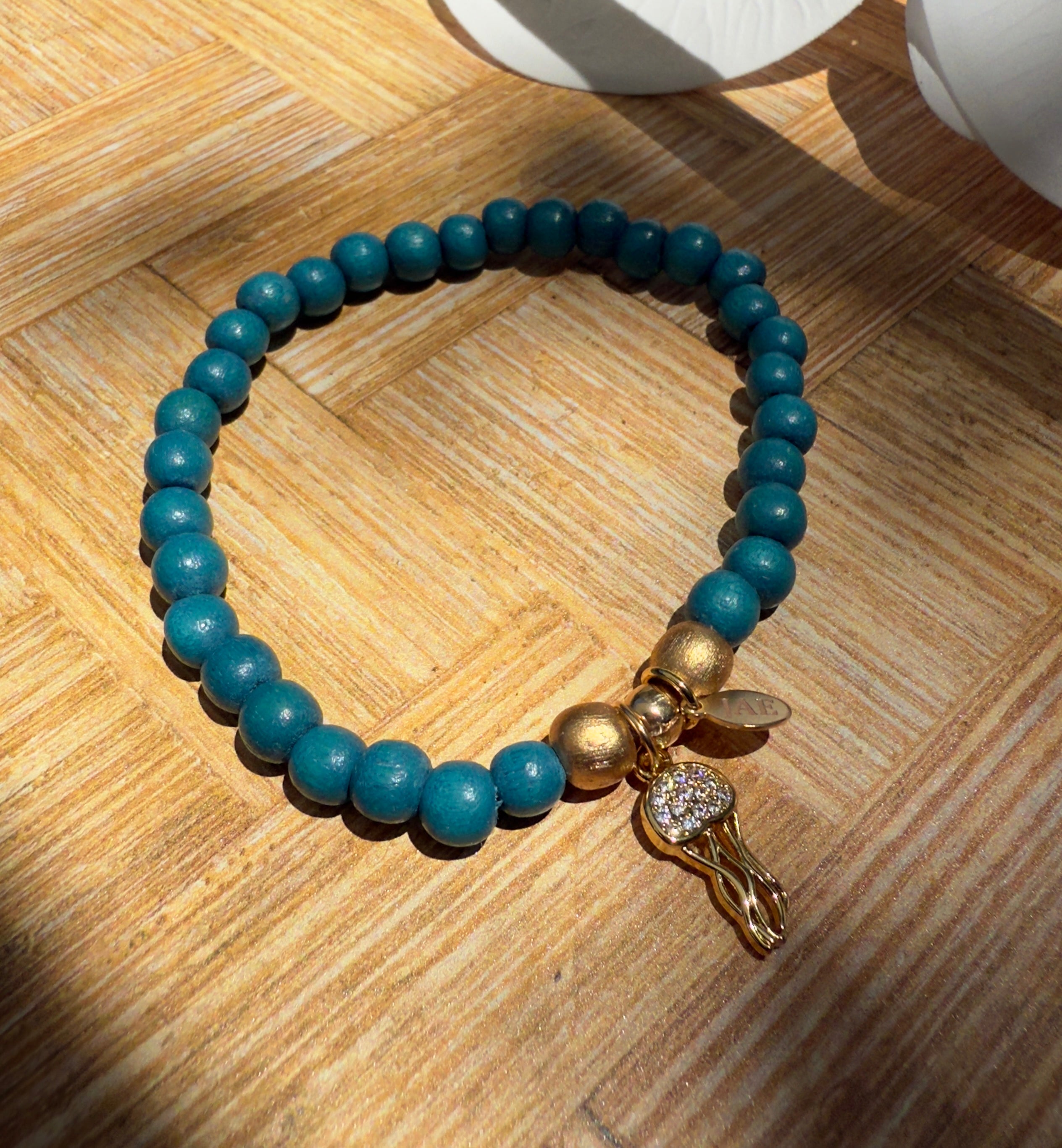 Teal Colored Wooden Bead Slip-on Style Bracelet with Jellyfish with CZ Charm