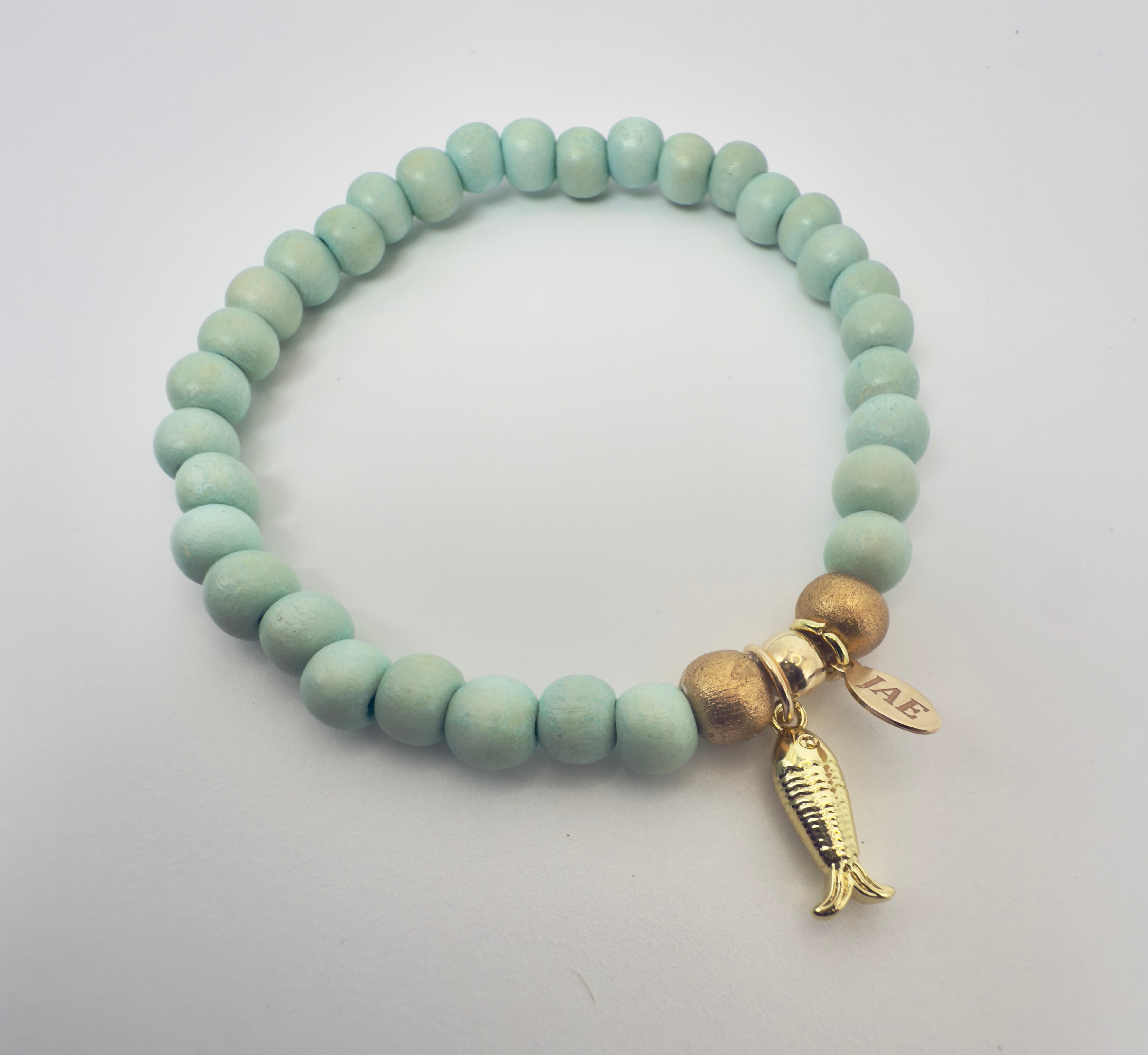 Seafoam Colored Wooden Bead Slip-on Style Bracelet with Textured Fish Charm