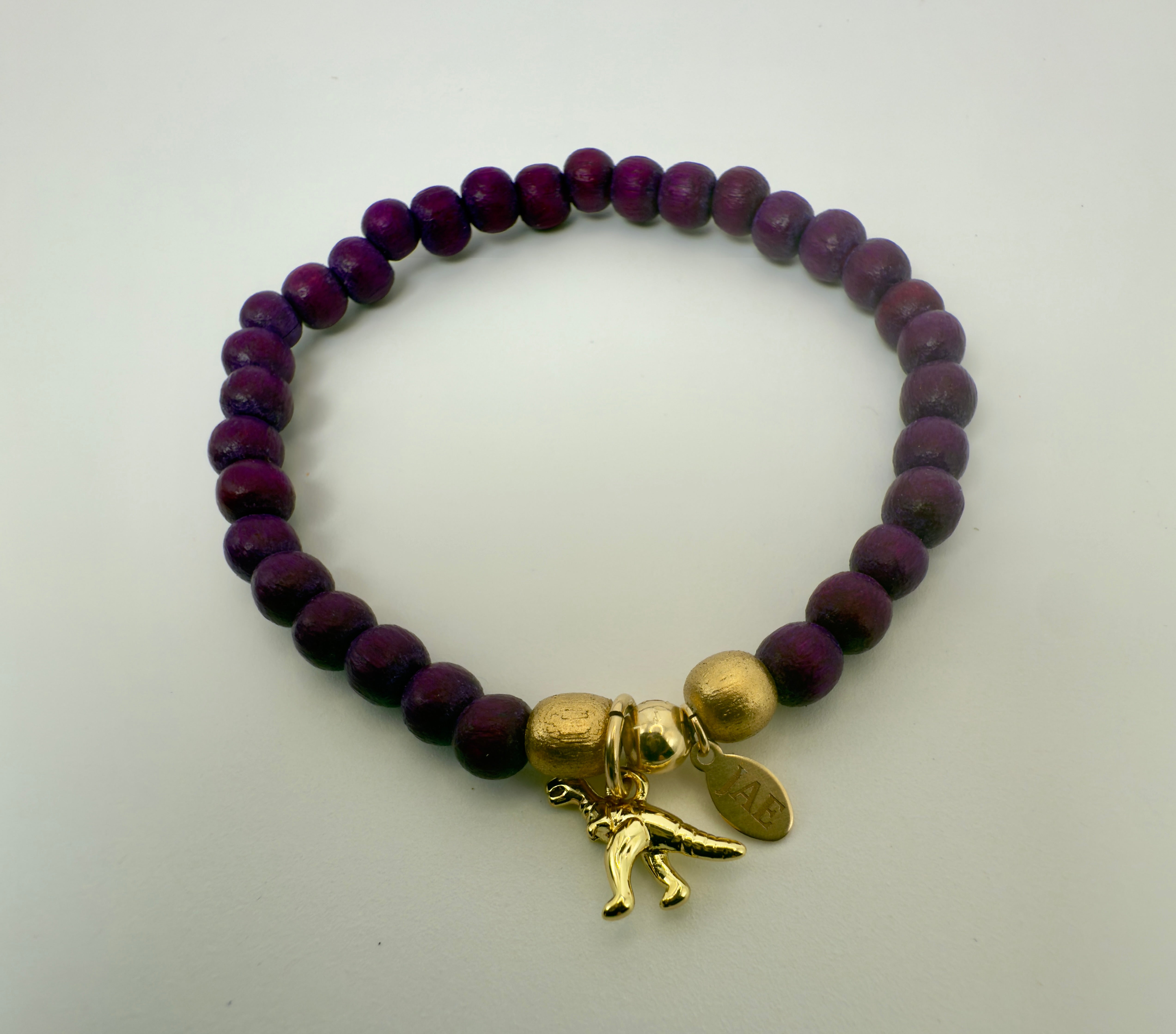 Cranberry Colored Wooden Bead Slip-on Style Bracelet with T-Rex Charm