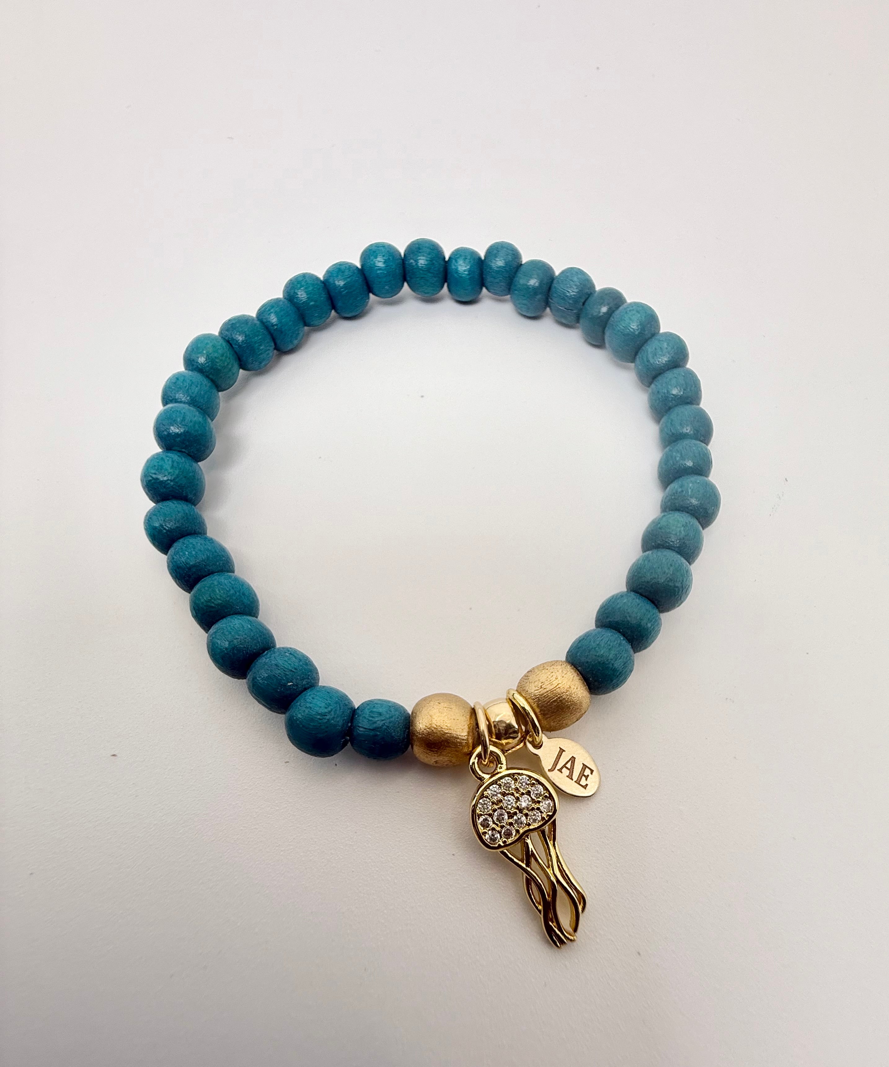 Teal Colored Wooden Bead Slip-on Style Bracelet with Jellyfish with CZ Charm