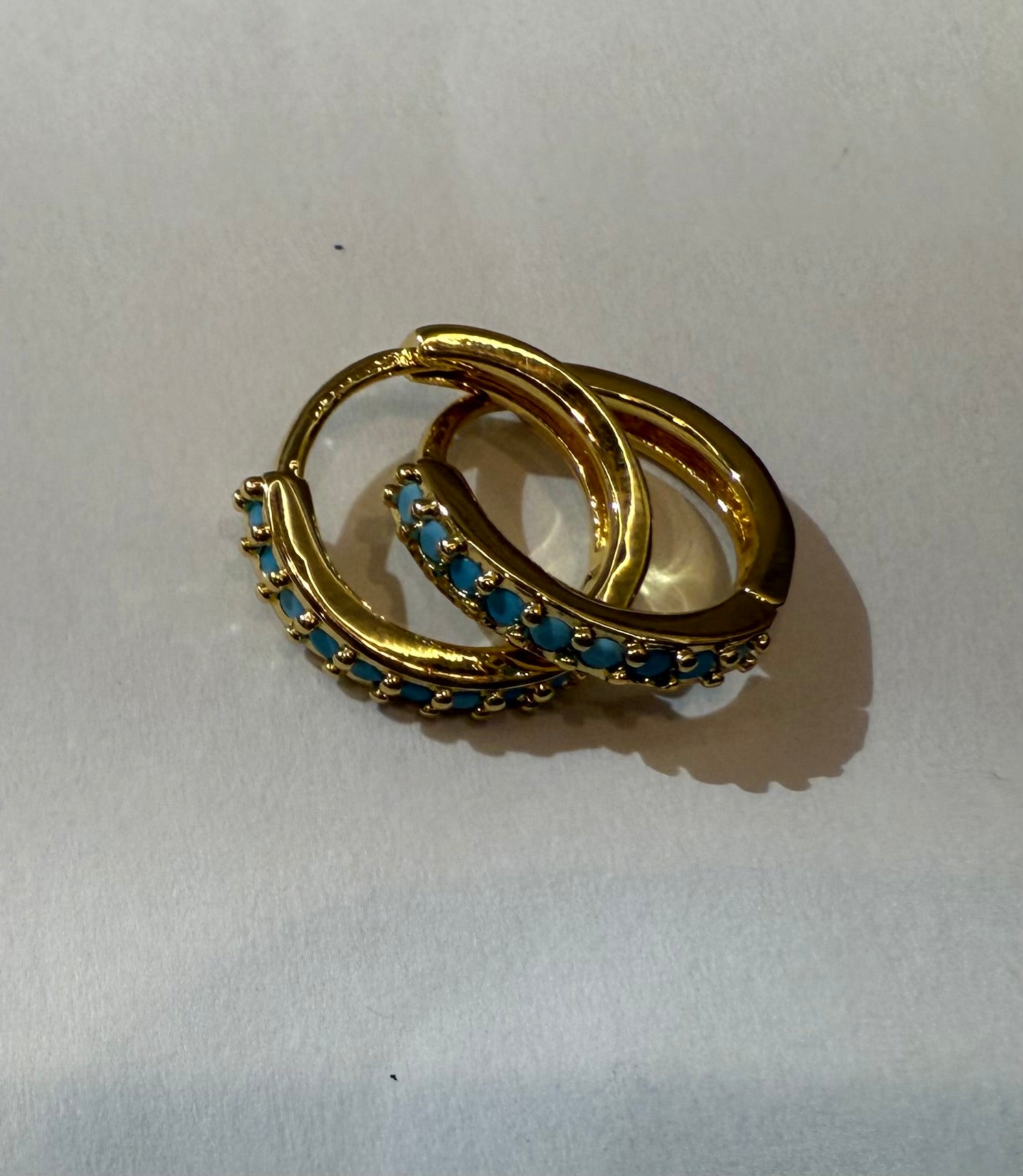 The Luca  - Huggie Style Hoop Earrings with Turquoise Colored Cubic Zirconia Accents