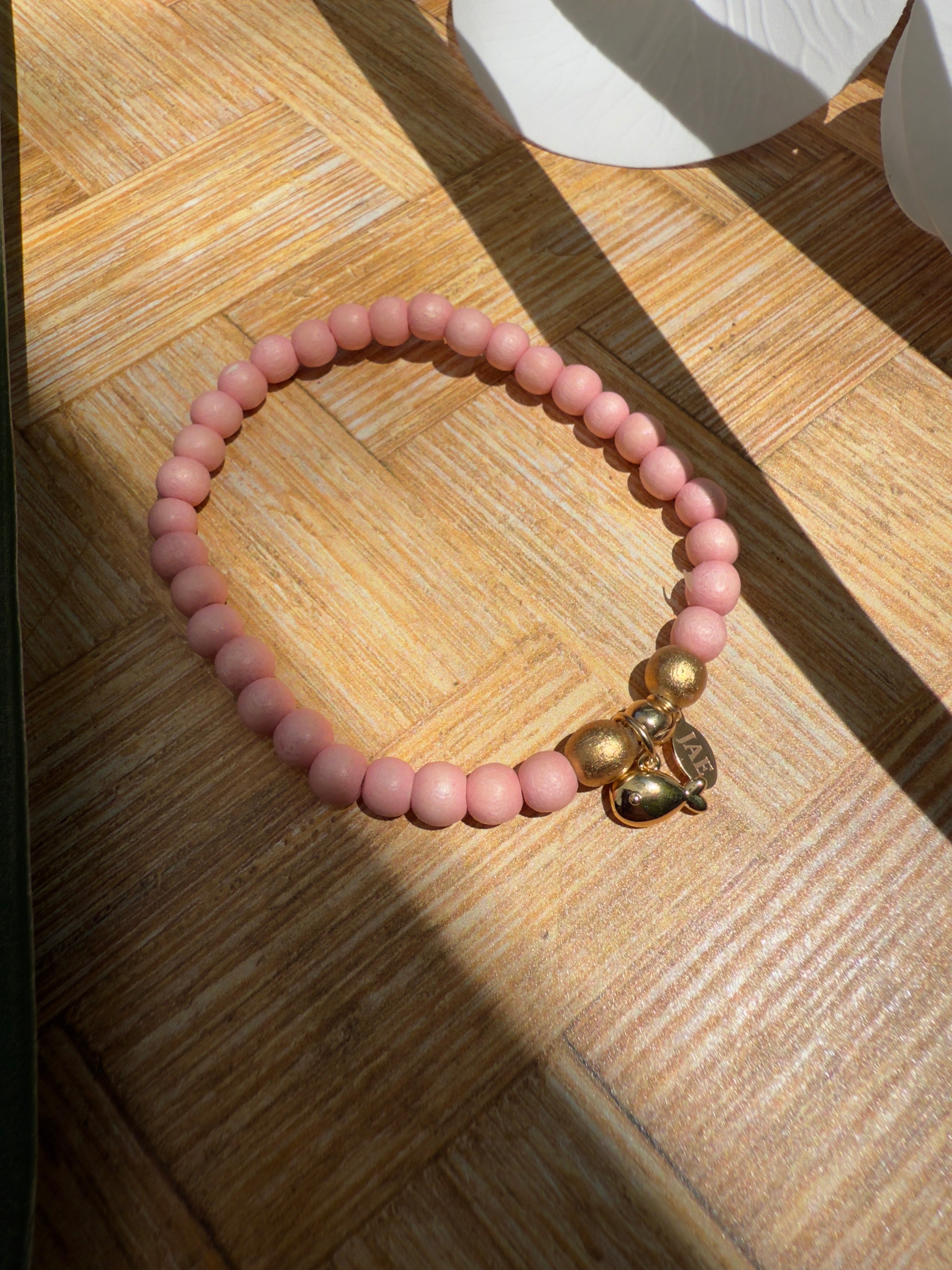 Pink Wooden Bead Slip-on Style Bracelet with Gold Fish Charm